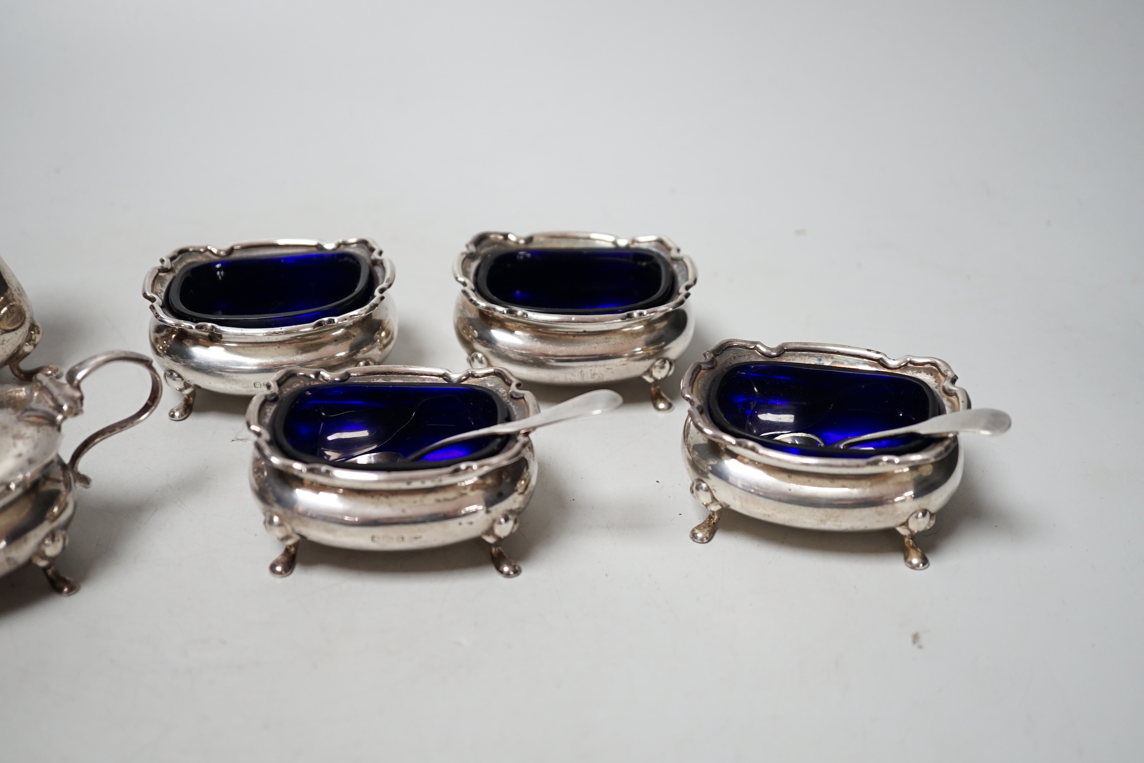 Two four piece silver cruet sets.